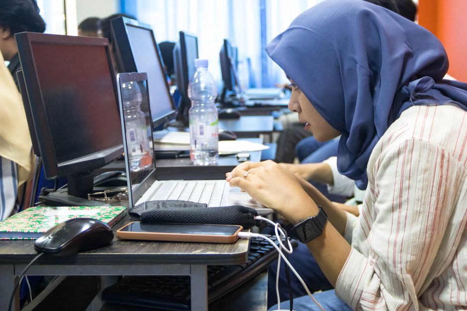 A student working on a laptop during a digital skills session